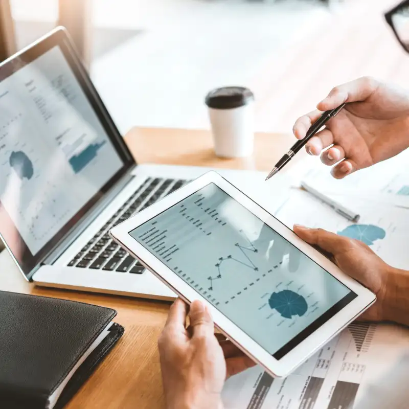 Two people looking at business analytics