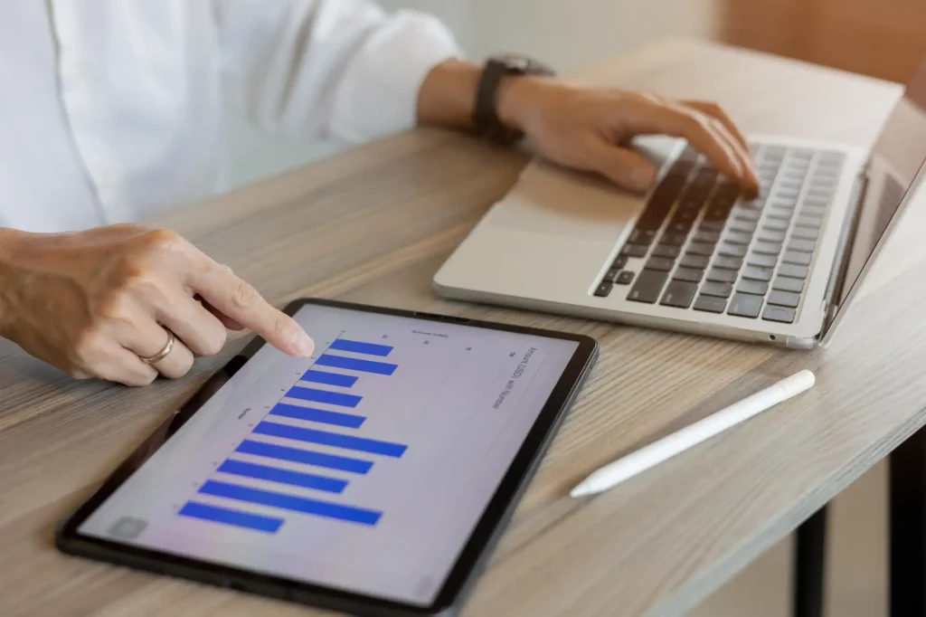 Person looking at laptop and tablet